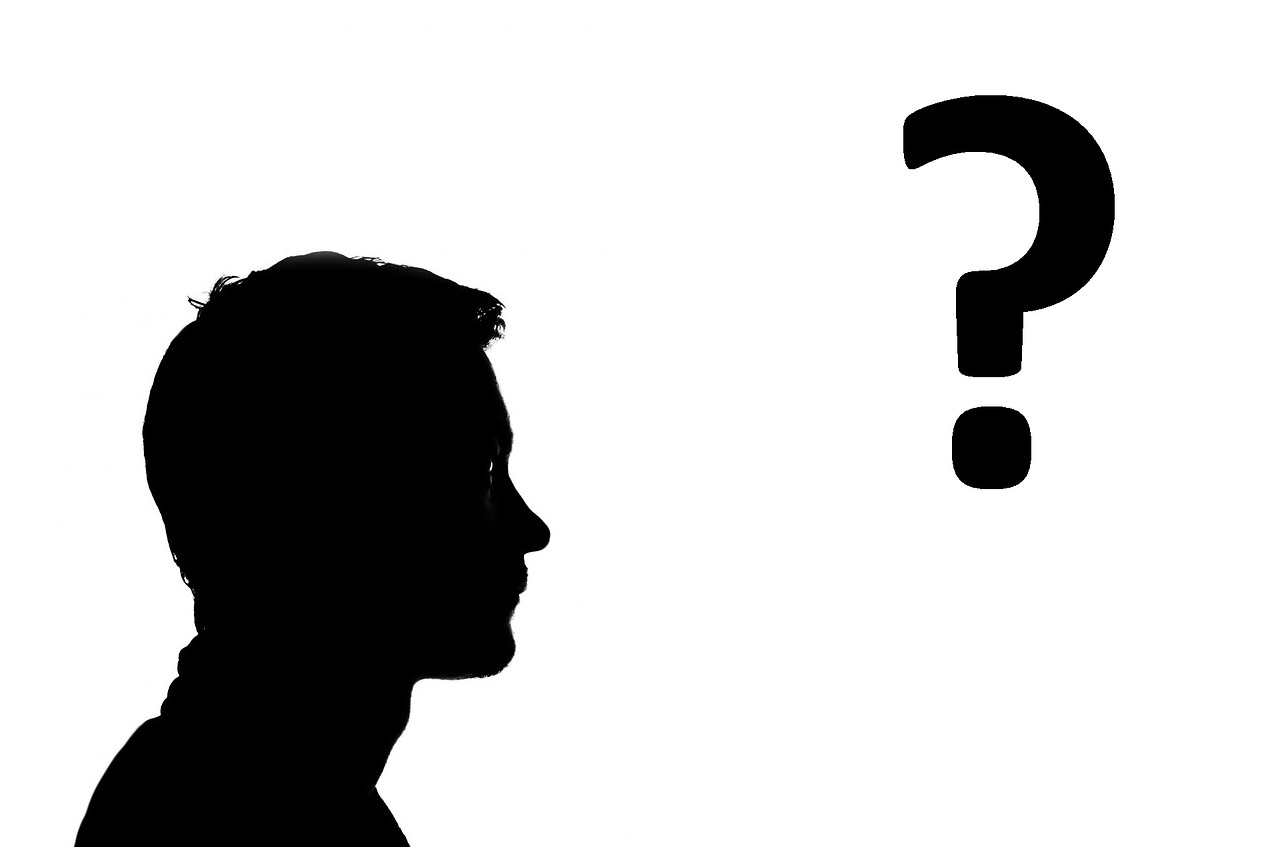 a person in silhouette with a question mark